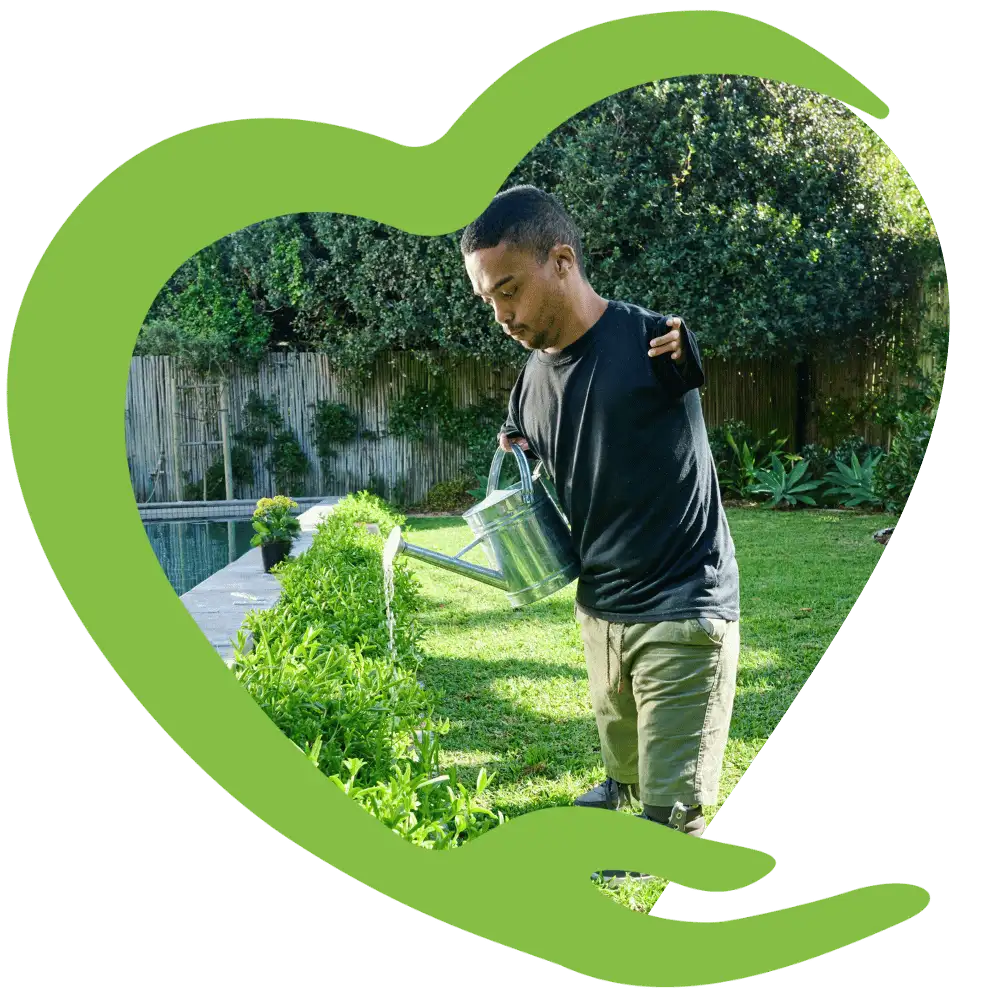 Disabled man in the garden watering plants