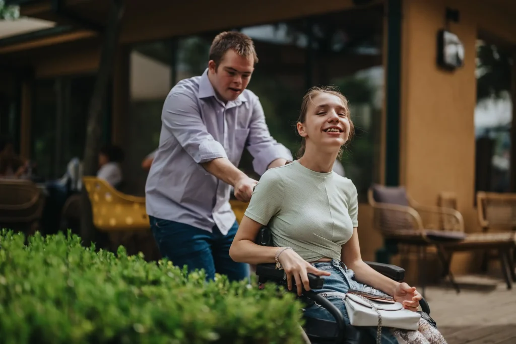 Disabled girl in wheelchair with friend
