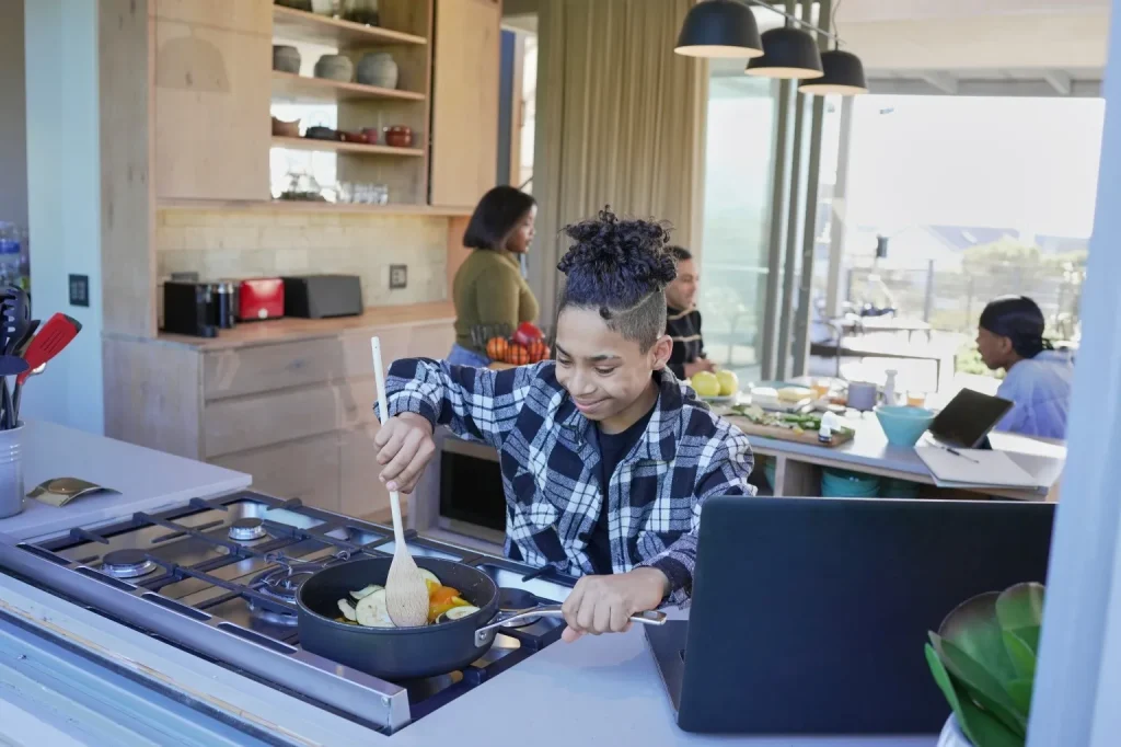 Young boy cooking at home
